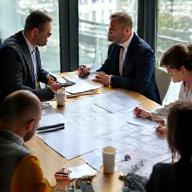 Meeting discussing technical drawings