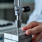 Quality control engineer using precision measurement tools